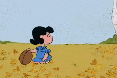 Lucy pulling football away from Charlie Brown